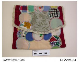 Bag, sachet for stockings or handkerchiefs, hand pieced patchwork of overlapping circles of assorted colourful dress and lingerie fabrics in silk and rayon crepe, each piece outlined with featherstitch in twisted thread, the background fabric is of maro