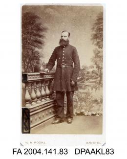 Photograph, Mr John Nicholls, policeman, wearing uniform standing by a balustrade with his helmet placed upon it, taken by W H Moore of Bristolvol 1, page 13