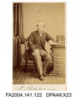 Photograph, Mr C Barnes, Chief Clerk, seated by an ornate desk, taken by The London Portrait Companyvol 1, page 17 - Counsel for Infant, during the various proceedings -