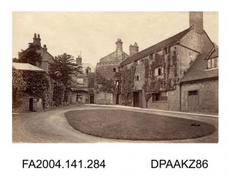 Photograph, the courtyard at Knoyle House, Wiltshire, showing a man up a long laddervol 1, page 36 - Views of Knoyle House, Wilts. Seat of Henry Seymour Esquire.