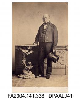 Photograph, unknown man standing top hat in hand beside an ornate table, taken by C T Newcombe of Londonvol 1, page 41 - In R v C Witnesses for Prosecution