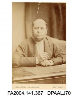 Photograph, unknown man, Usher in the Court of Queen's Bench, in legal dress sitting at a desk, taken by Herbert Watkins and Haigh of Londonvol 1, page 44 - Judge, Counsel and Solicitors engaged for the Claimant at the Trial in the Common Pleas
