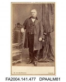 Photograph, Mr Howleston of Poole, standing leaning against an ornate chair, taken by W W Burnand of Poolevol 1, page 56