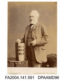 Photograph, Mr Frederick Bowker senior, solicitor, standing with his hand resting on a large volume entitled Tichborne v Lushington vol 5, taken by The London Stereoscopic Company
vol 1, page 72