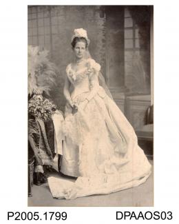 Photograph, black and white, showing Miss K H Bignell in court dress, Basingstoke, Hampshire. 1895