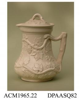 Jug, earthenware, with a grating before the lip suggesting it was intended for fruit punch, decorated with 'Vintage' design, a relief-moulded pattern of vines and a crabstock handle; base, two moulded cartouches and registered design mark with encoded d