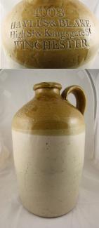 Brown and cream stoneware jug used for wine or spirits and used by Hayles & Blake High St & Kingsgate St Winchester. Also stamped with the manufacturer's mark of Powell, Bristol.